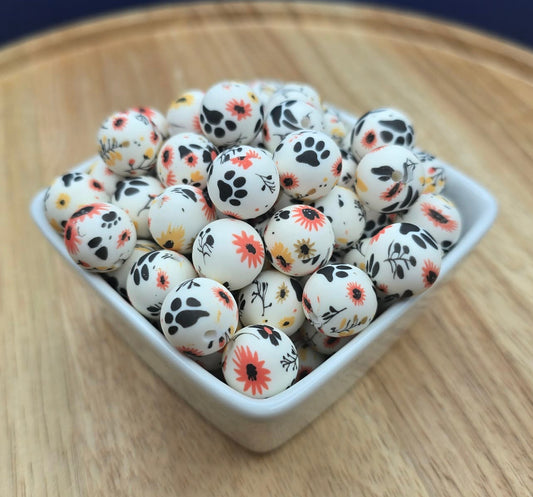 White container filled with small decorative beads on a wooden surface with a dark blue background